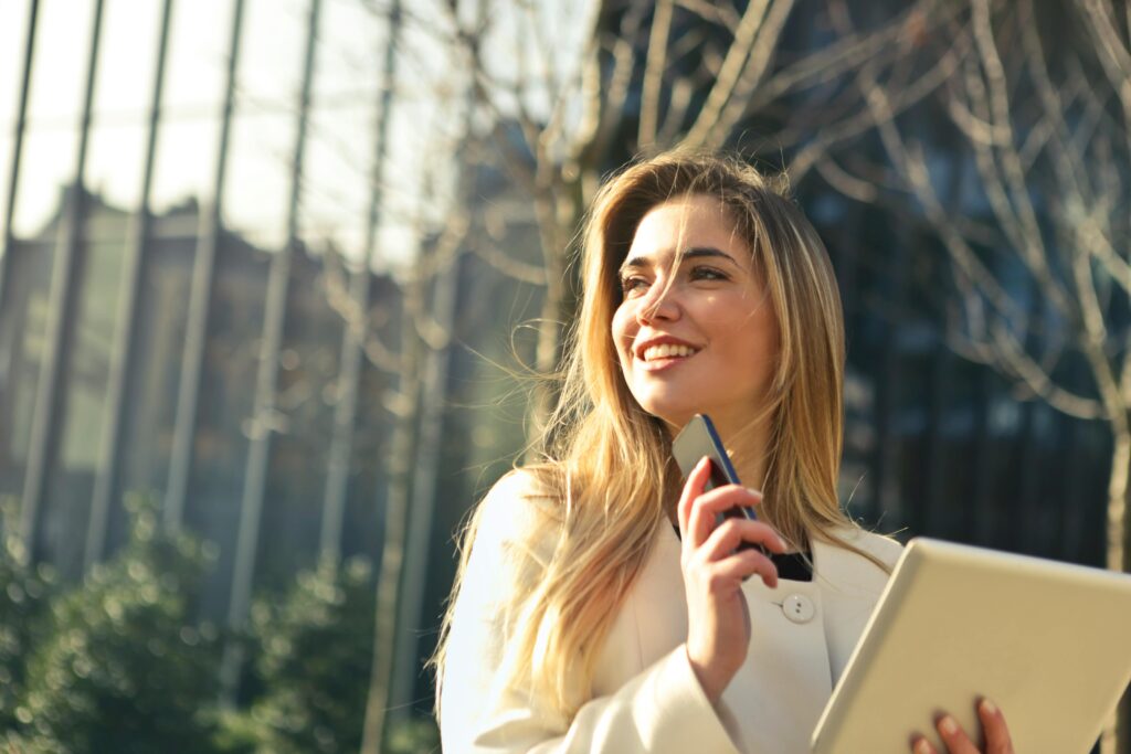 pexels-photo-864994-864994 Woman Wearing White Top Holding Smartphone and Tablet